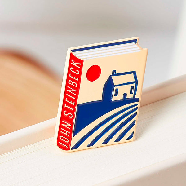 John Steinbeck enamel book pin for independent bookstores, illustration by Judy Kaufmann