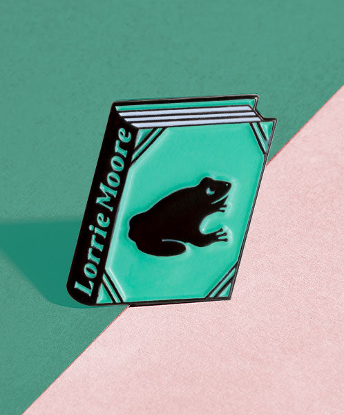 Lorrie Moore enamel book pin for independent bookstores and concept shops, illustration by Judy Kaufmann