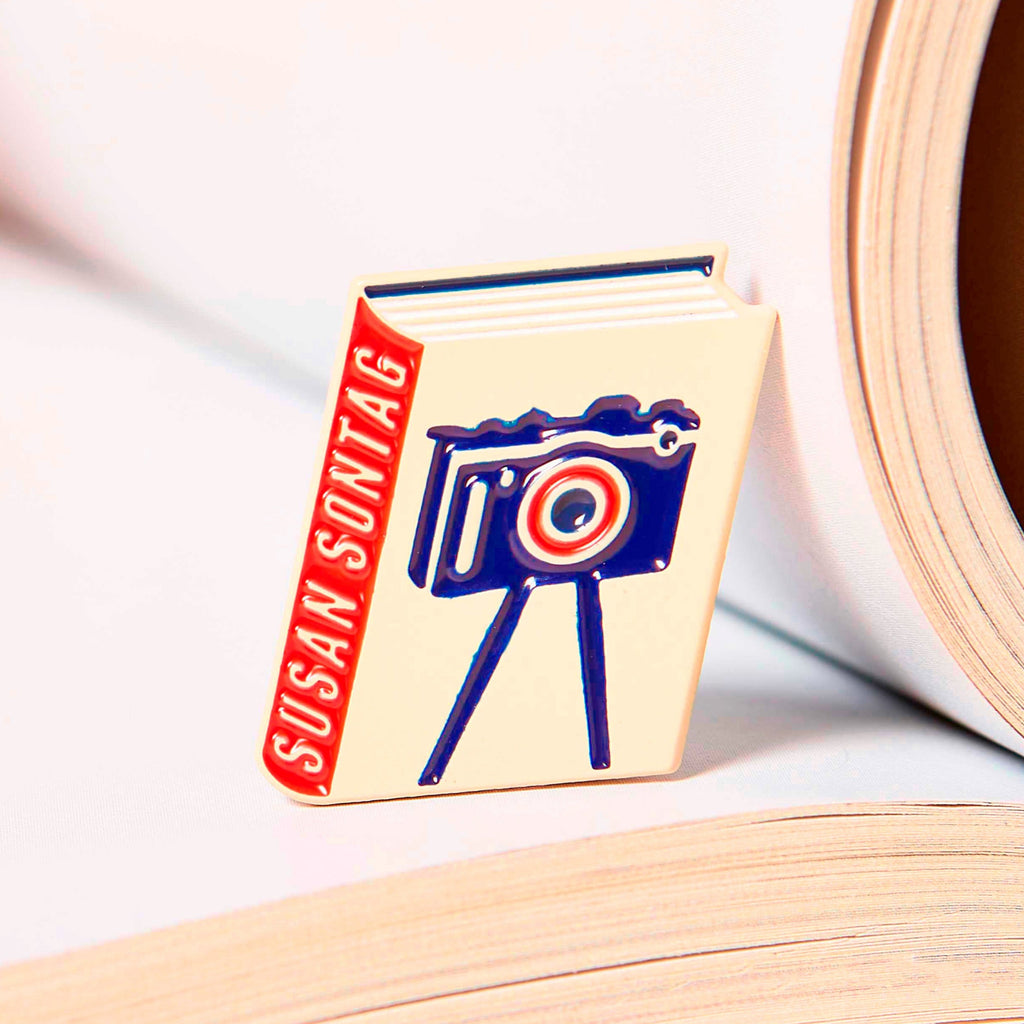 Susan Sontag enamel book pin for independent bookstores, illustration by Judy Kaufmann