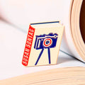 Susan Sontag enamel book pin for independent bookstores, illustration by Judy Kaufmann